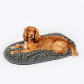 Danish Design Sherpa Fleece Quilted Mattress Dog Bed in Charcoal Arrow Design with a dog laying on the bed #Colour_Charcoal Arrows (Tonal Greys)