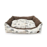Rectangular beige dog bed with farmyard animal patterns, including tractors and cows, with a brown rim around the edges.