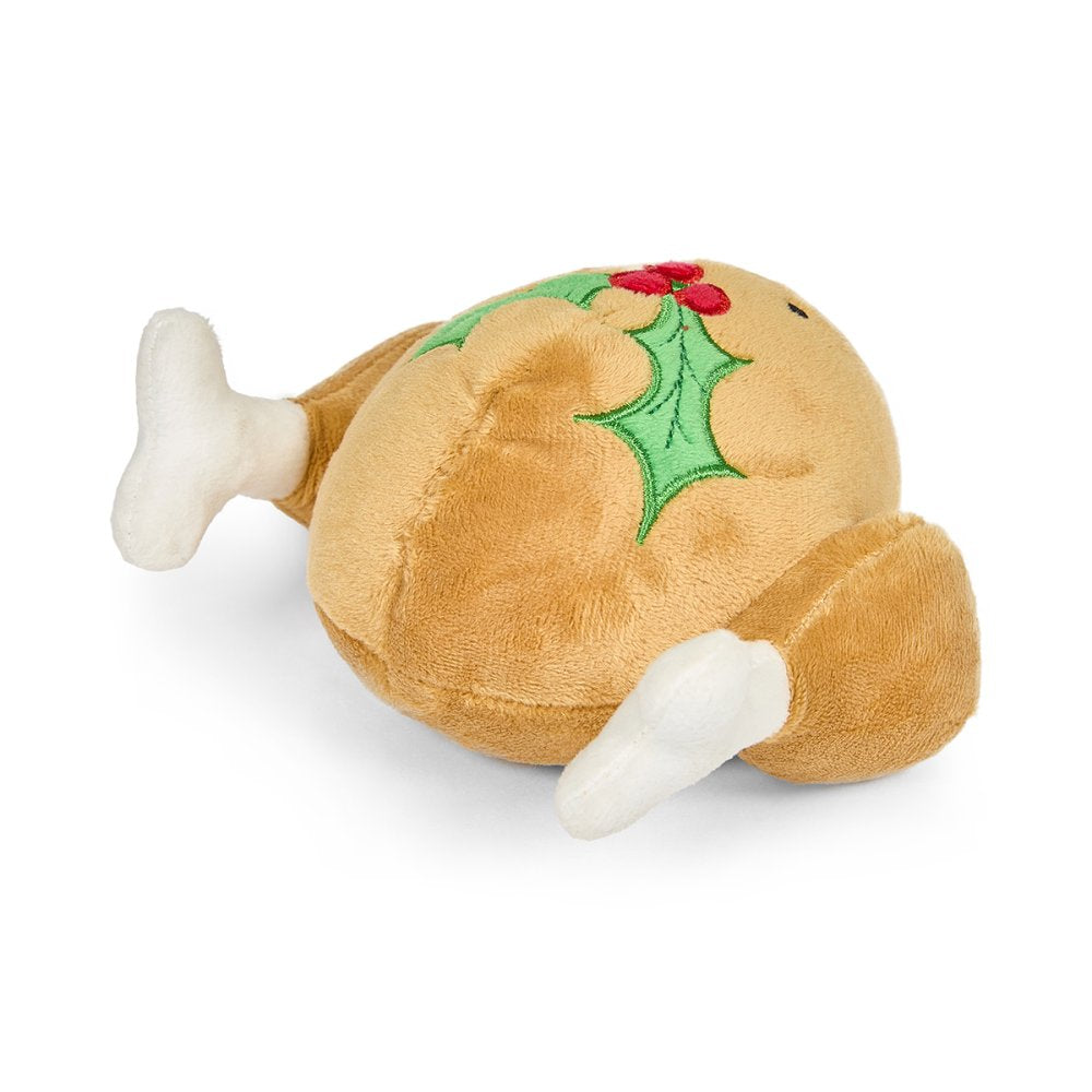 Plush toy resembling a roast turkey with holly leaves and berriesback view
