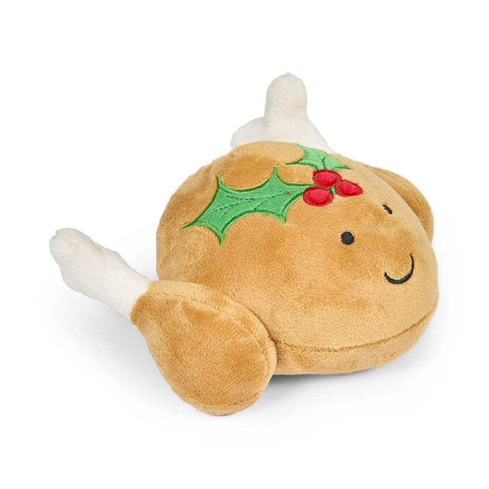 Plush dog toy resembling a roast turkey with holly leaves and berries 